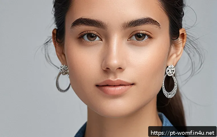 여성용 드롭 이어링 추천 - A close-up portrait of a young woman with an oval face shape wearing minimalist drop earrings made o...